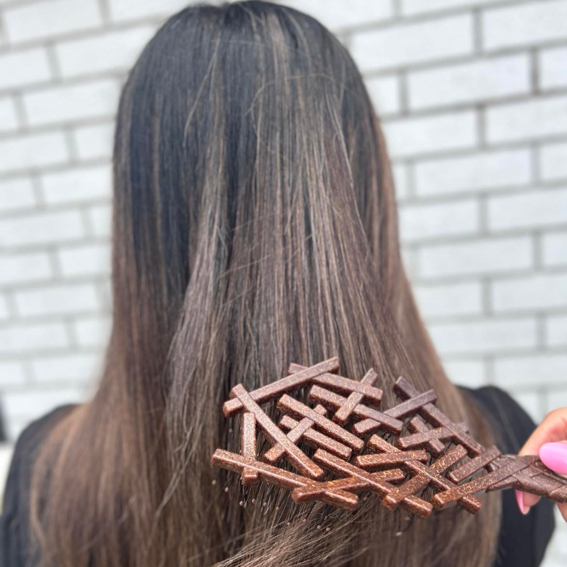 Our coco detangling brush being used on hair by Lust Haircare NZ