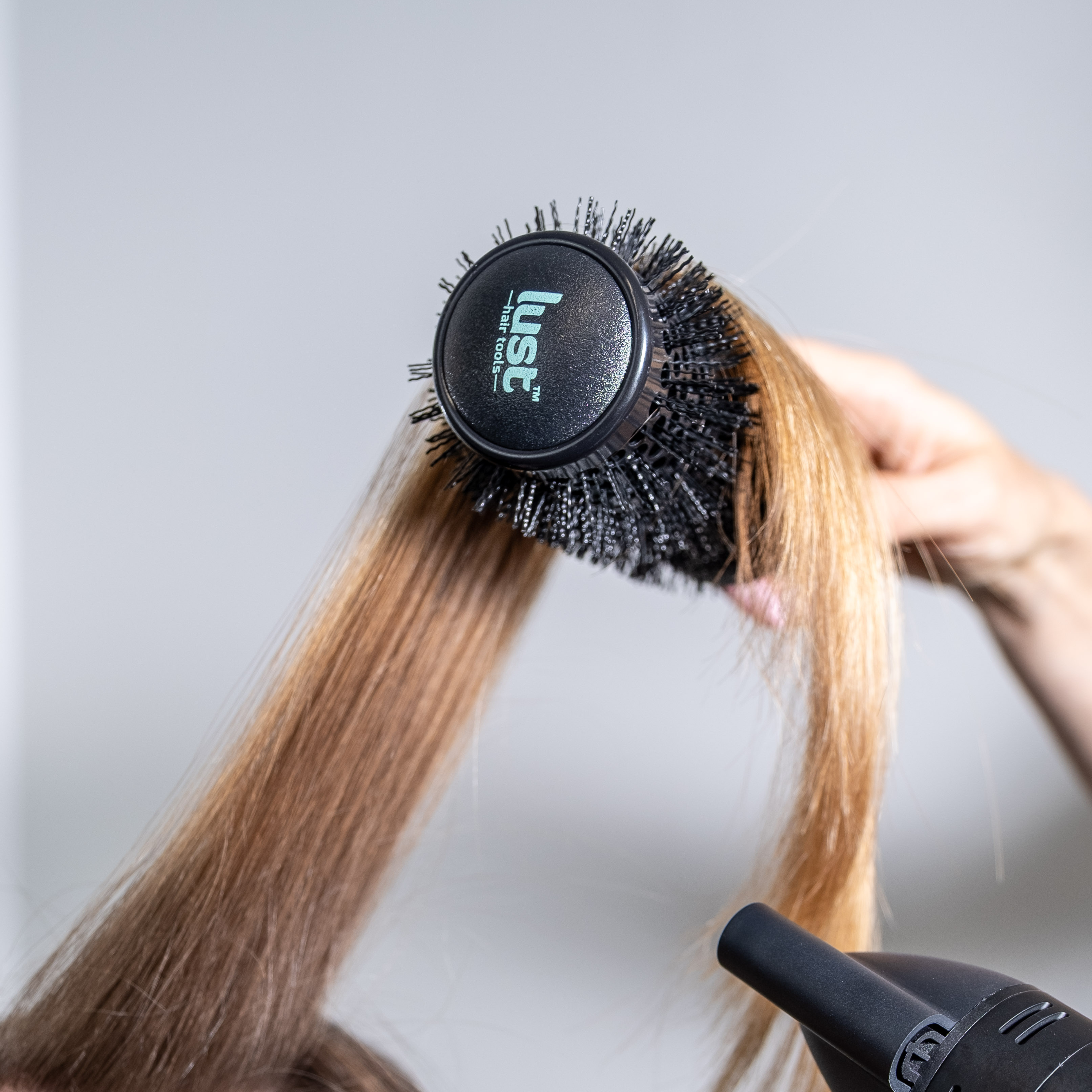 Lust haircare NZ luxury ceramic hairbrush in use