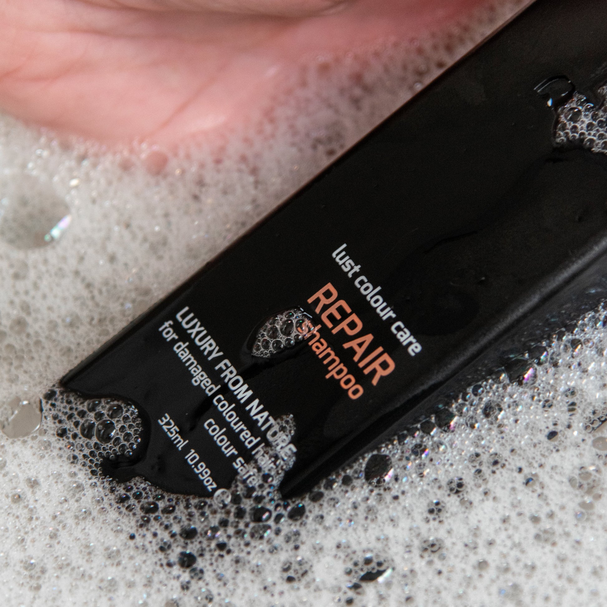Bottle of our repair shampoo for damaged hair by Lust Haircare NZ